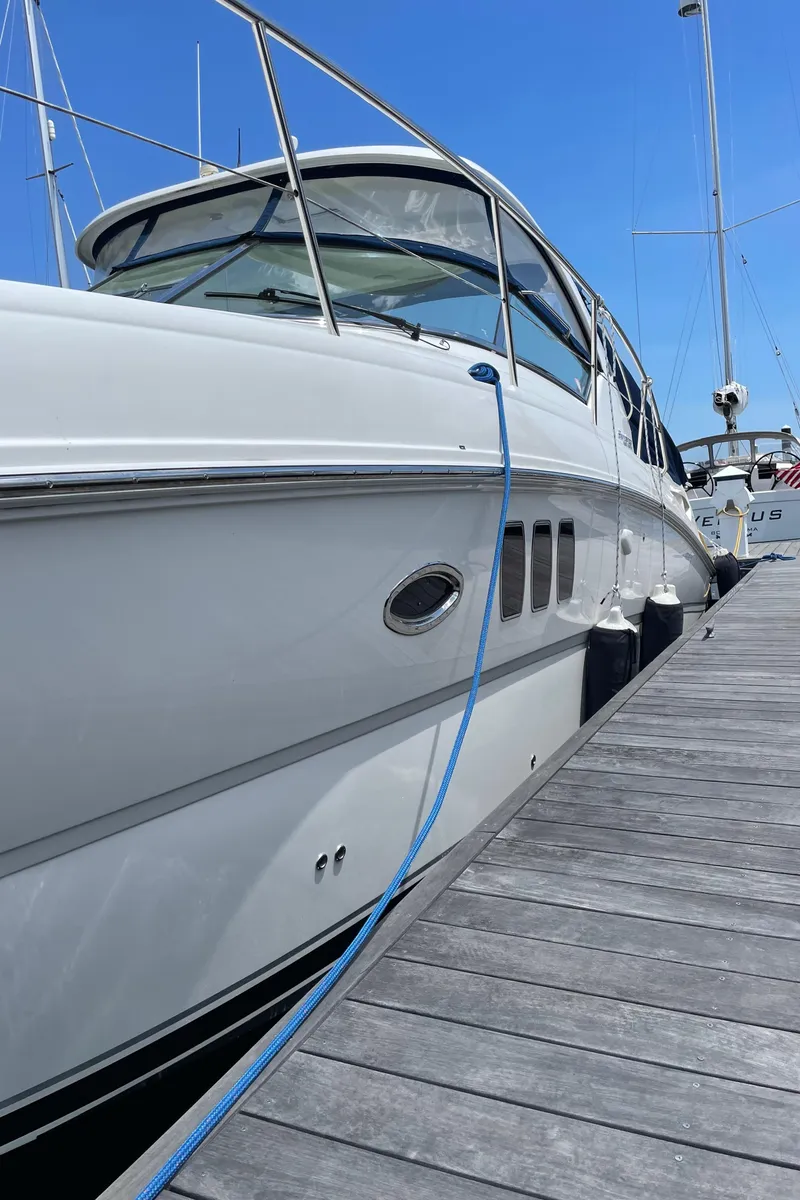 Slide: The Image of 2011 Sea Ray 390 Sundancer yacht docked at marina under clear blue sky. - 11