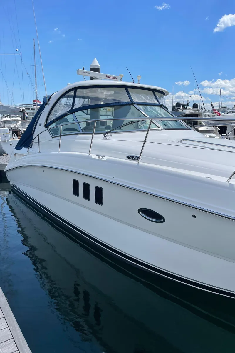 Slide: The Image of 2011 Sea Ray 390 Sundancer docked at marina under clear blue sky. - 12