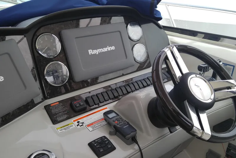 Slide: The Image of Control panel of 2011 Sea Ray 390 Sundancer with Raymarine navigation system and steering wheel. - 14