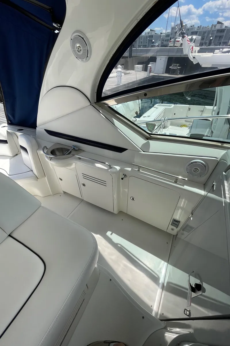 Slide: The Image of 2011 Sea Ray 390 Sundancer interior with sleek white design and modern amenities. - 21