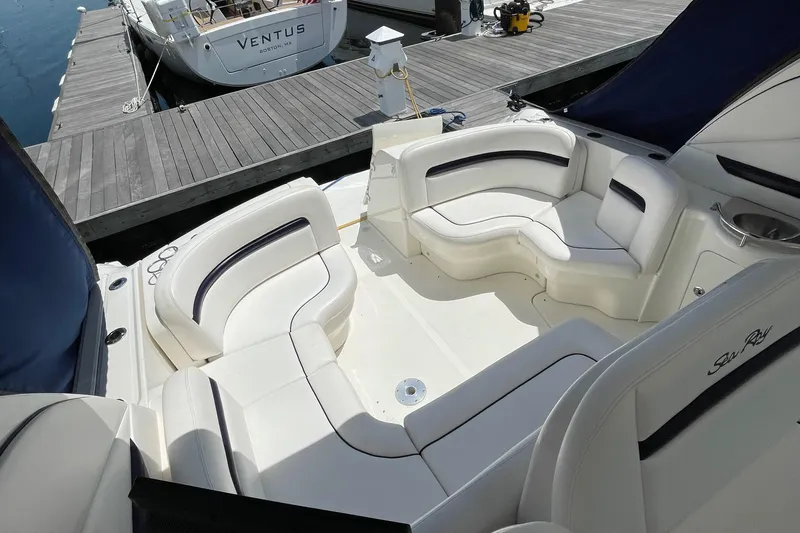 Slide: The Image of 2011 Sea Ray 390 Sundancer boat with spacious white seating area at dock. - 22