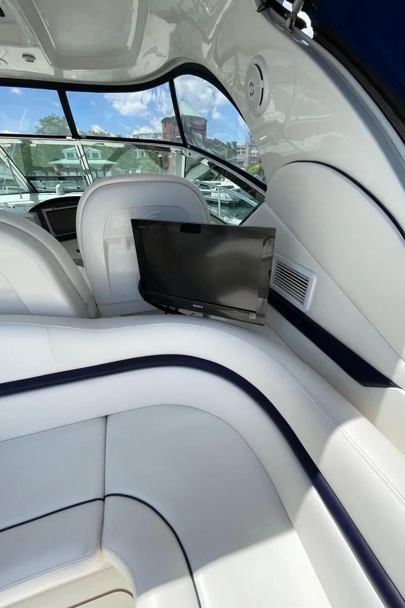 Slide: The Image of Luxurious interior of 2011 Sea Ray 390 Sundancer yacht with sleek seating and a mounted TV. - 24