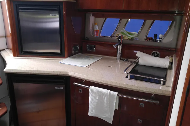 Slide: The Image of Interior of 2011 Sea Ray 390 Sundancer yacht kitchen with modern amenities. - 30