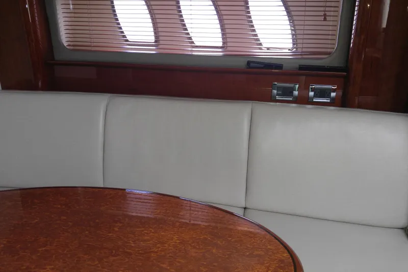 Slide: The Image of Interior of 2011 Sea Ray 390 Sundancer with leather seating and wooden table. - 31