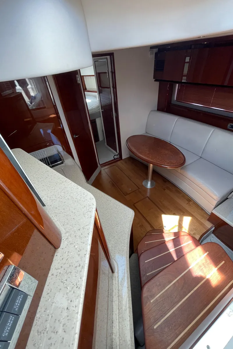 Slide: The Image of Interior of 2011 Sea Ray 390 Sundancer yacht with seating and table. - 32