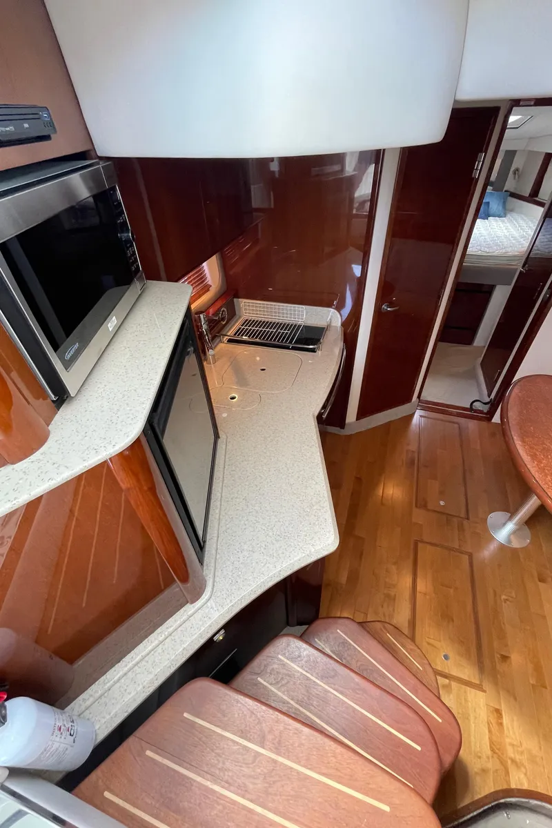 Slide: The Image of Interior of 2011 Sea Ray 390 Sundancer yacht with modern kitchen and wood flooring. - 34