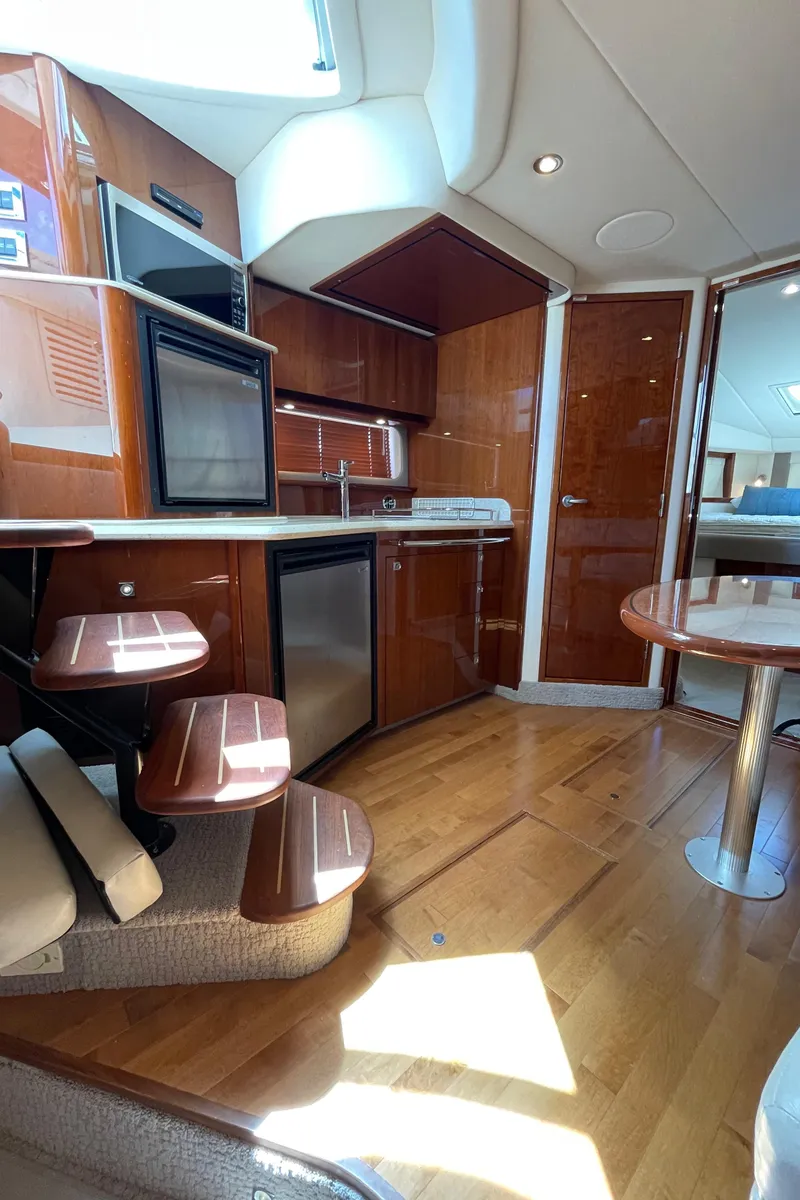 Slide: The Image of Luxurious interior of 2011 Sea Ray 390 Sundancer yacht with modern kitchen amenities. - 36
