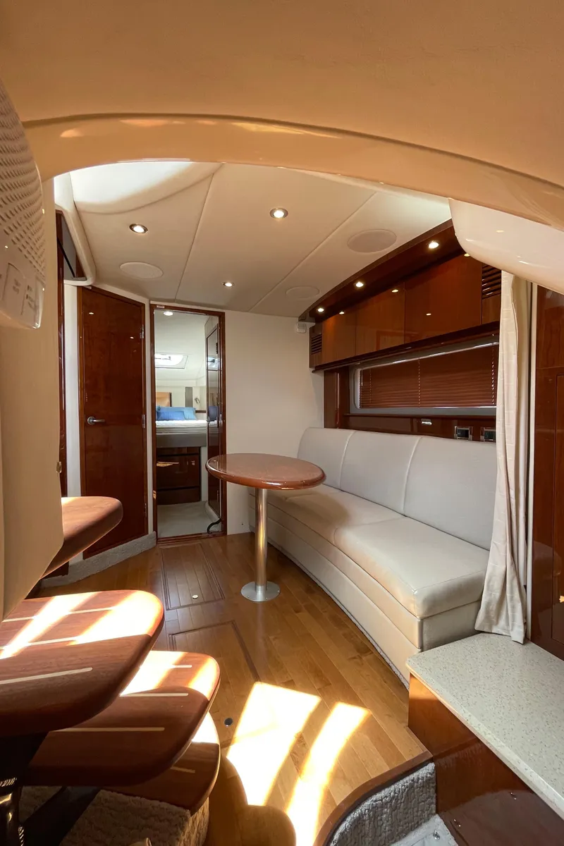 Slide: The Image of Interior of 2011 Sea Ray 390 Sundancer yacht with elegant seating and wooden finishes. - 37