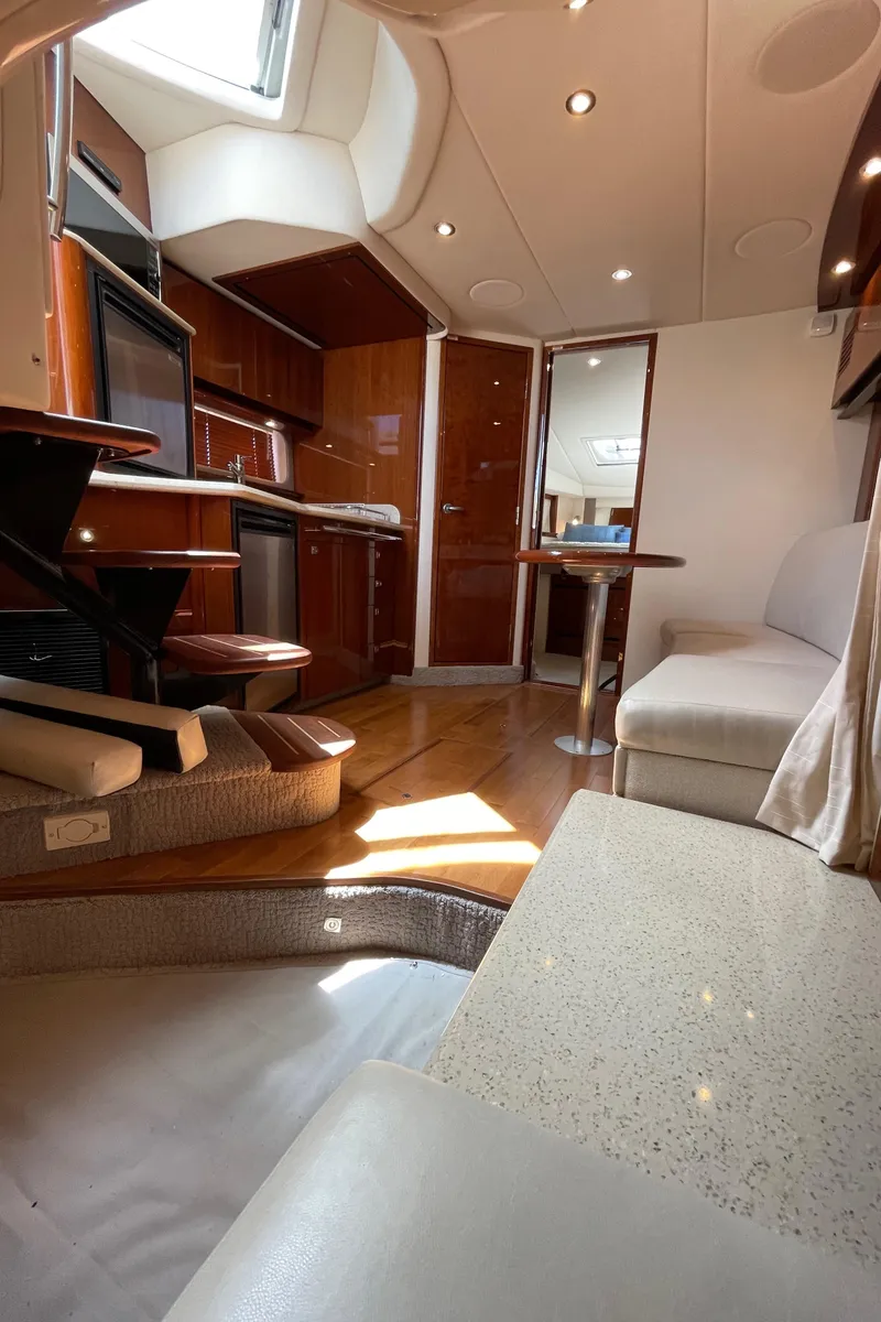 Slide: The Image of Interior of 2011 Sea Ray 390 Sundancer yacht with modern kitchen and seating area. - 38