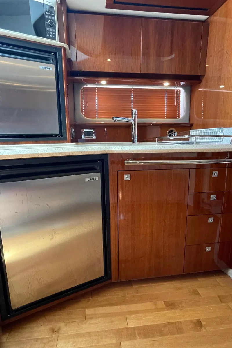 Slide: The Image of Luxurious kitchen interior of 2011 Sea Ray 390 Sundancer yacht with wood cabinetry. - 39