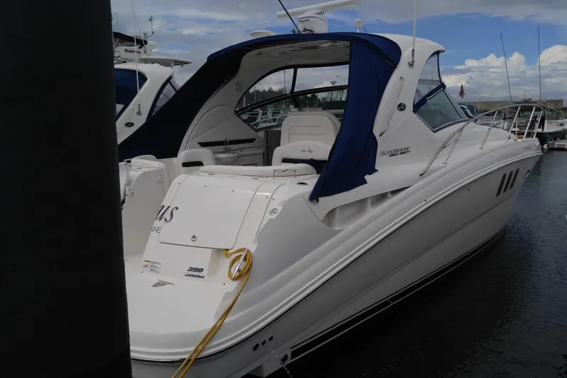 Slide: The Image of 2011 Sea Ray 390 Sundancer yacht docked with blue canopy and sleek design. - 4