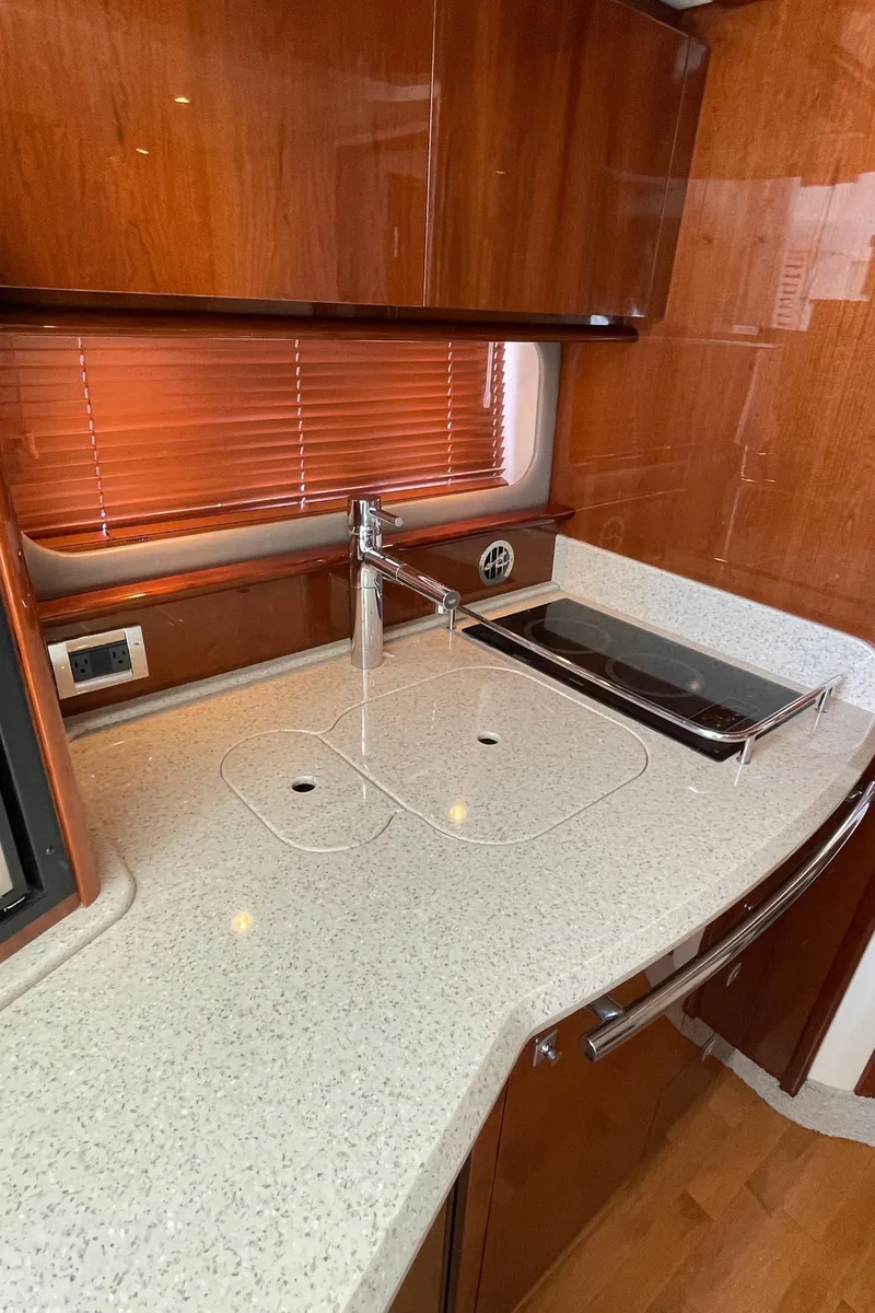 Slide: The Image of 2011 Sea Ray 390 Sundancer yacht kitchen with sleek countertops and modern fixtures. - 41