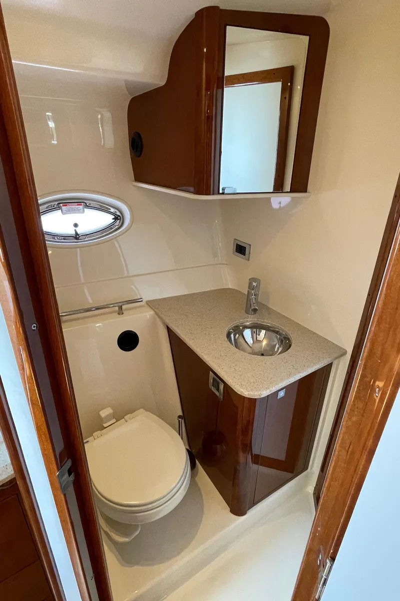 Slide: The Image of 2011 Sea Ray 390 Sundancer bathroom with sink, toilet, and mirror. - 42