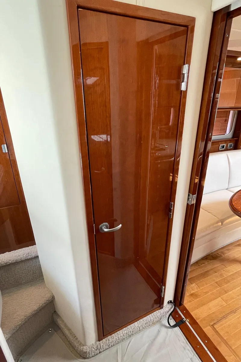 Slide: The Image of Wooden door inside 2011 Sea Ray 390 Sundancer yacht, leading to cabin area. - 43