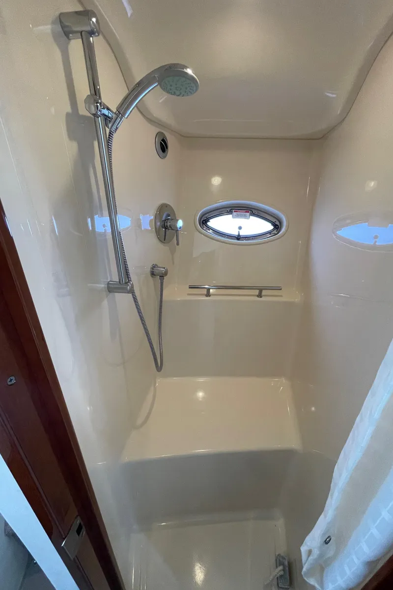Slide: The Image of 2011 Sea Ray 390 Sundancer shower with porthole and modern fixtures. - 44