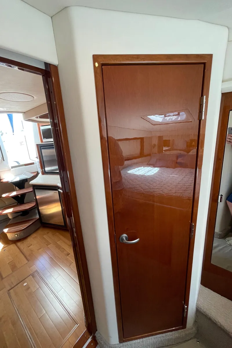Slide: The Image of Interior view of 2011 Sea Ray 390 Sundancer yacht, featuring wooden door and modern design. - 45