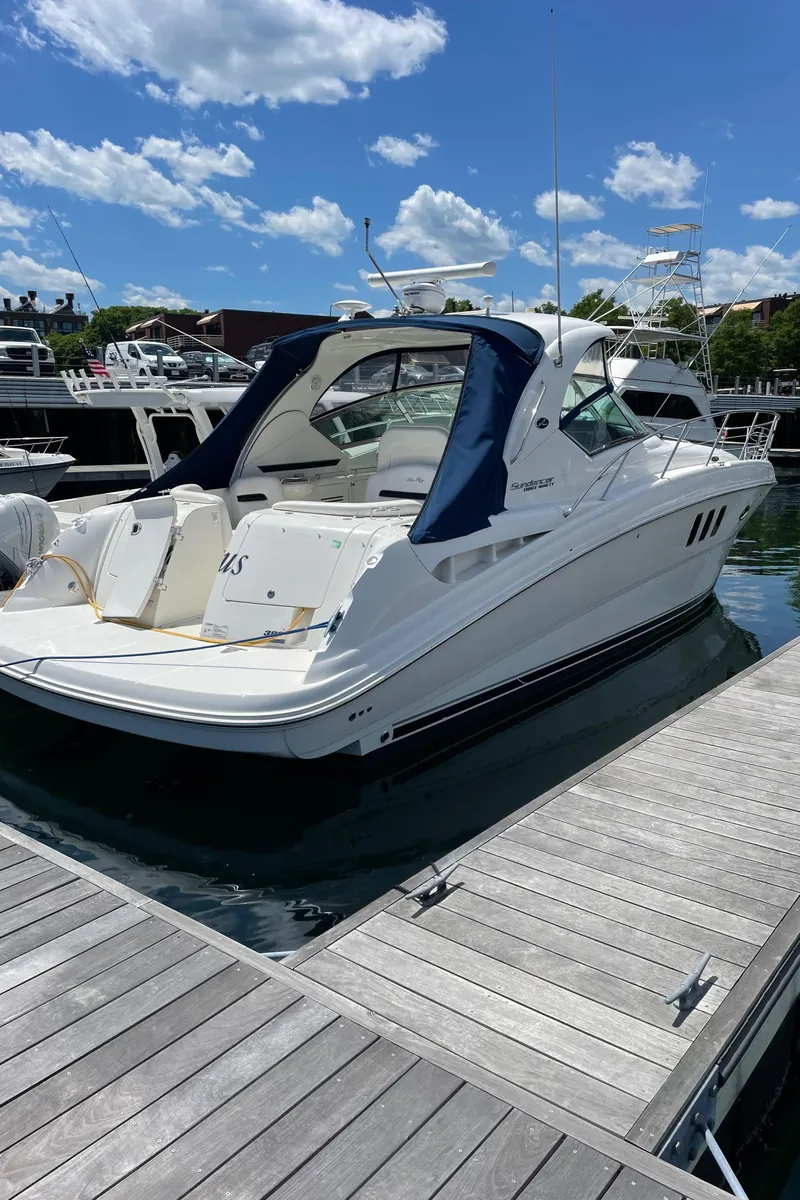 Slide: The Image of 2011 Sea Ray 390 Sundancer docked at marina under blue sky. - 5