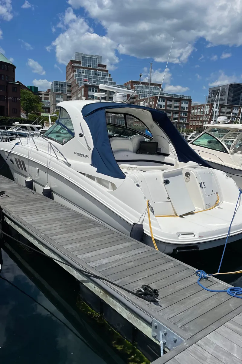 Slide: The Image of 2011 Sea Ray 390 Sundancer docked at marina, under a partly cloudy sky. - 8