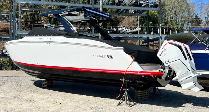 Slide: The Image of 2023 Cobalt R33 boat on dry dock with outboard motor. - 2