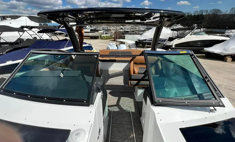 Slide: The Image of 2023 Cobalt R33 boat with open cockpit and modern design at a marina. - 5