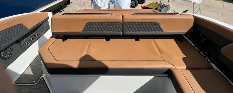 Slide: The Image of Cobalt R33 2023 model boat with tan leather seating and black accents. - 7