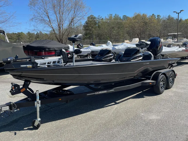 Slide: The Image of 2023 Vexus AVX 2080 fishing boat on a trailer in a parking lot. - 2