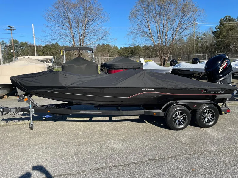 Slide: The Image of 2023 Vexus AVX 2080 boat with cover on trailer in outdoor lot. - 4