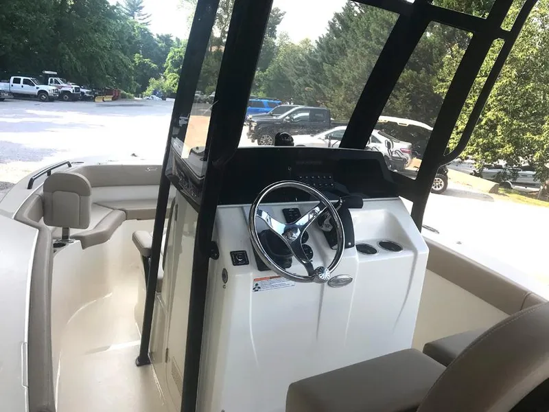 Slide: The Image of 2023 Scout 215 XSF boat interior with steering console and seating. - 11