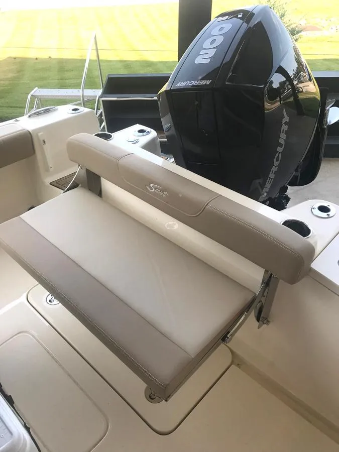 Slide: The Image of 2023 Scout 215 XSF boat with Mercury engine and cushioned seating. - 12