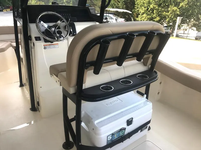 Slide: The Image of 2023 Scout 215 XSF boat interior with steering console and rod holders. - 13