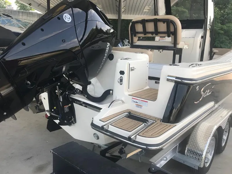 Slide: The Image of 2023 Scout 215 XSF boat with outboard motor and trailer. - 3