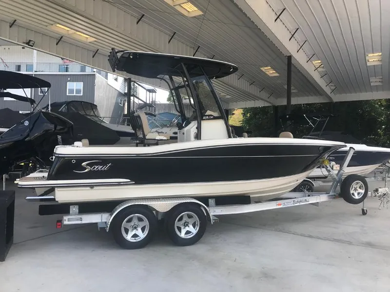 Slide: The Image of 2023 Scout 215 XSF boat on a trailer in a covered storage area. - 4