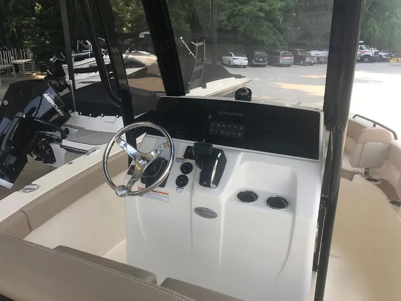 Slide: The Image of 2023 Scout 215 XSF boat cockpit with steering wheel and controls. - 6