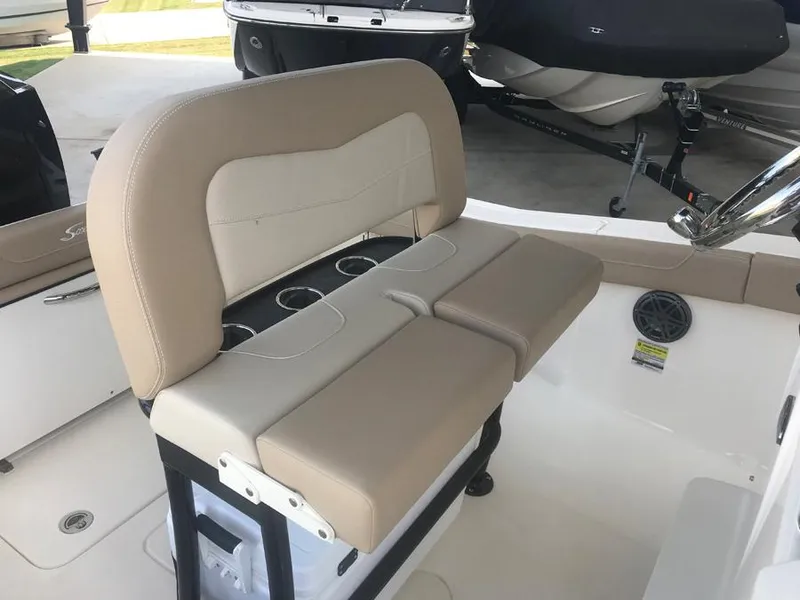 Slide: The Image of 2023 Scout 215 XSF boat with beige and white cushioned seating. - 7