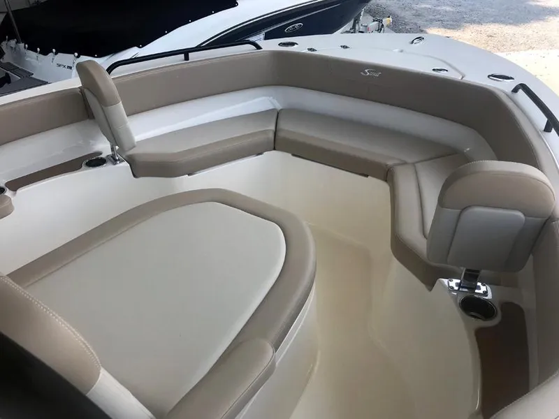 Slide: The Image of 2023 Scout 215 XSF boat interior with beige and white cushioned seating. - 8