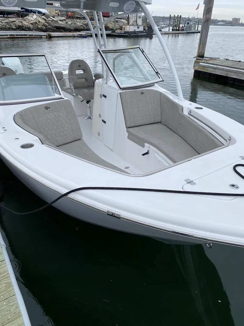 Slide: The Image of 2023 Sea Pro 240 DC boat docked, featuring spacious seating and modern design. - 3