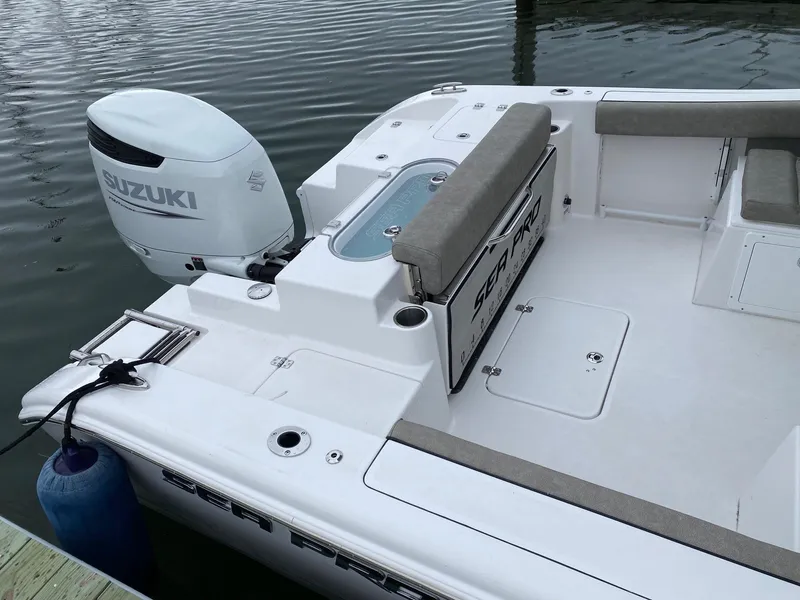 Slide: The Image of 2023 Sea Pro 240 DC boat with Suzuki outboard motor docked. - 7