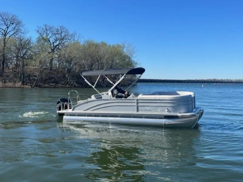 Slide: The Image of 2023 Harris CRUISER 230 SLDH pontoon boat on a calm lake. - 10