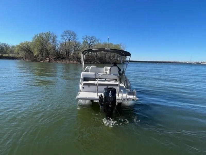 Slide: The Image of 2023 Harris CRUISER 230 SLDH pontoon boat on a lake. - 12