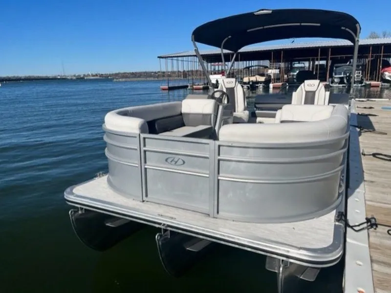Slide: The Image of 2023 Harris CRUISER 230 SLDH pontoon boat docked on a sunny day. - 15