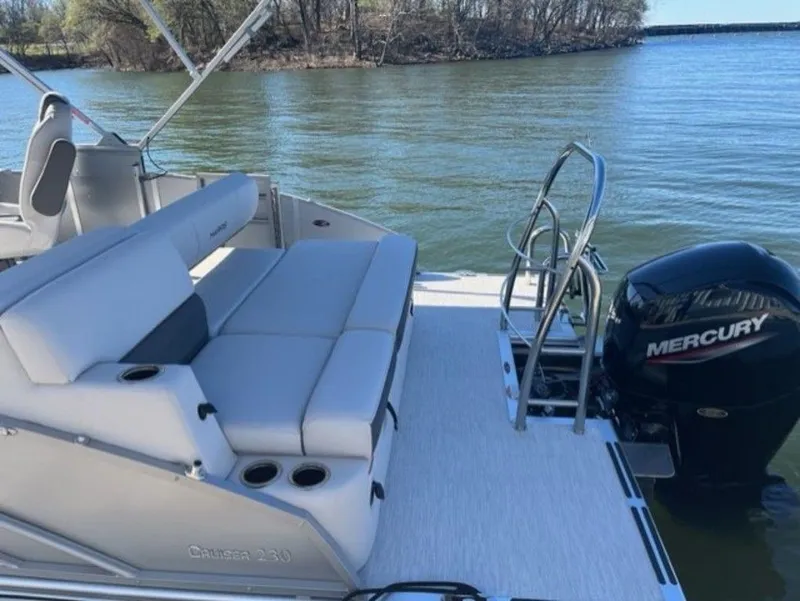 Slide: The Image of 2023 Harris CRUISER 230 SLDH pontoon boat with Mercury outboard engine on a lake. - 5