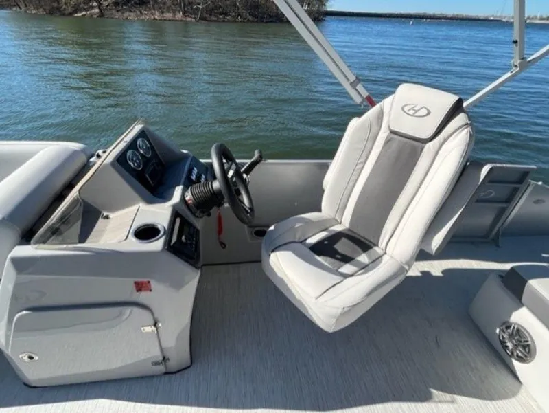 Slide: The Image of Captain's seat and helm of 2023 Harris CRUISER 230 SLDH pontoon boat on water. - 7