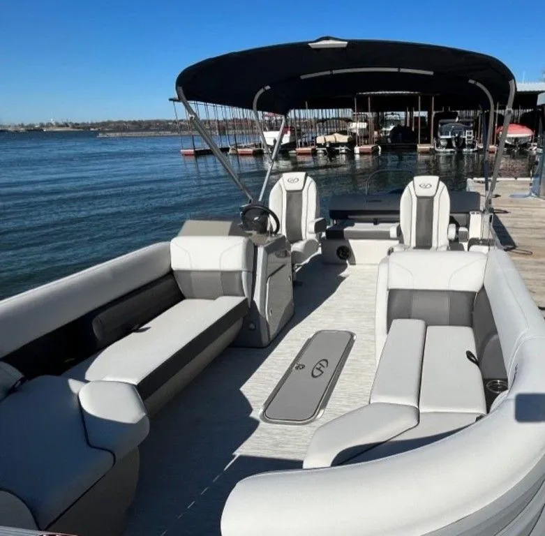 Slide: The Image of 2023 Harris CRUISER 230 SLDH pontoon boat with spacious seating and canopy docked by the lake. - 8