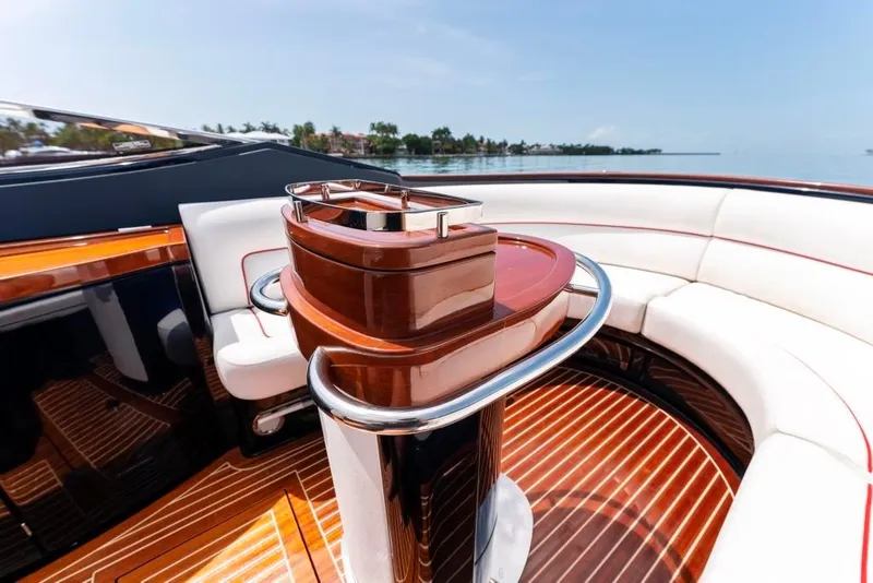 Slide: The Image of Interior of 2020 Riva Aquariva Super luxury yacht with polished wood and white seating. - 14