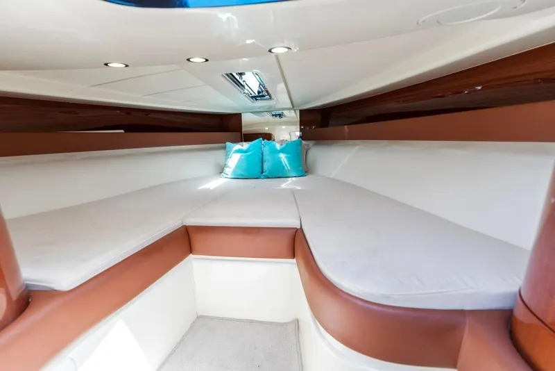 Slide: The Image of Interior cabin of 2020 Riva Aquariva Super with white and brown seating, turquoise pillows. - 21