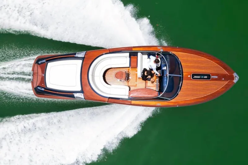 Slide: The Image of Aerial view of a 2020 Riva Aquariva Super speedboat cruising on green water. - 3