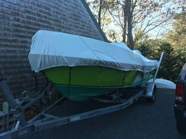 Slide: The Image of 1995 Aquasport 20 boat covered and on a trailer. - 3