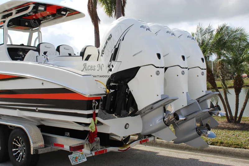 Slide: The Image of 2019 Renegade 33 Cuddy boat with triple outboard engines on a trailer. - 13