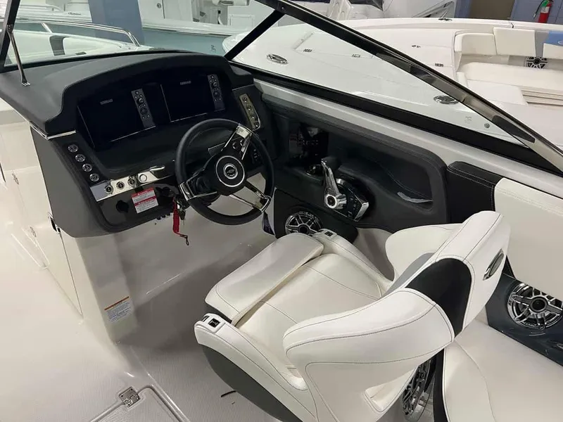 Slide: The Image of 2023 Chaparral 270 OSX boat cockpit with steering wheel and control panel. - 16