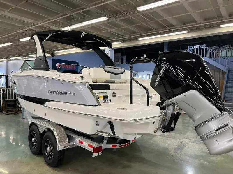 Slide: The Image of 2023 Chaparral 270 OSX boat on trailer in showroom with Mercury outboard motor. - 3